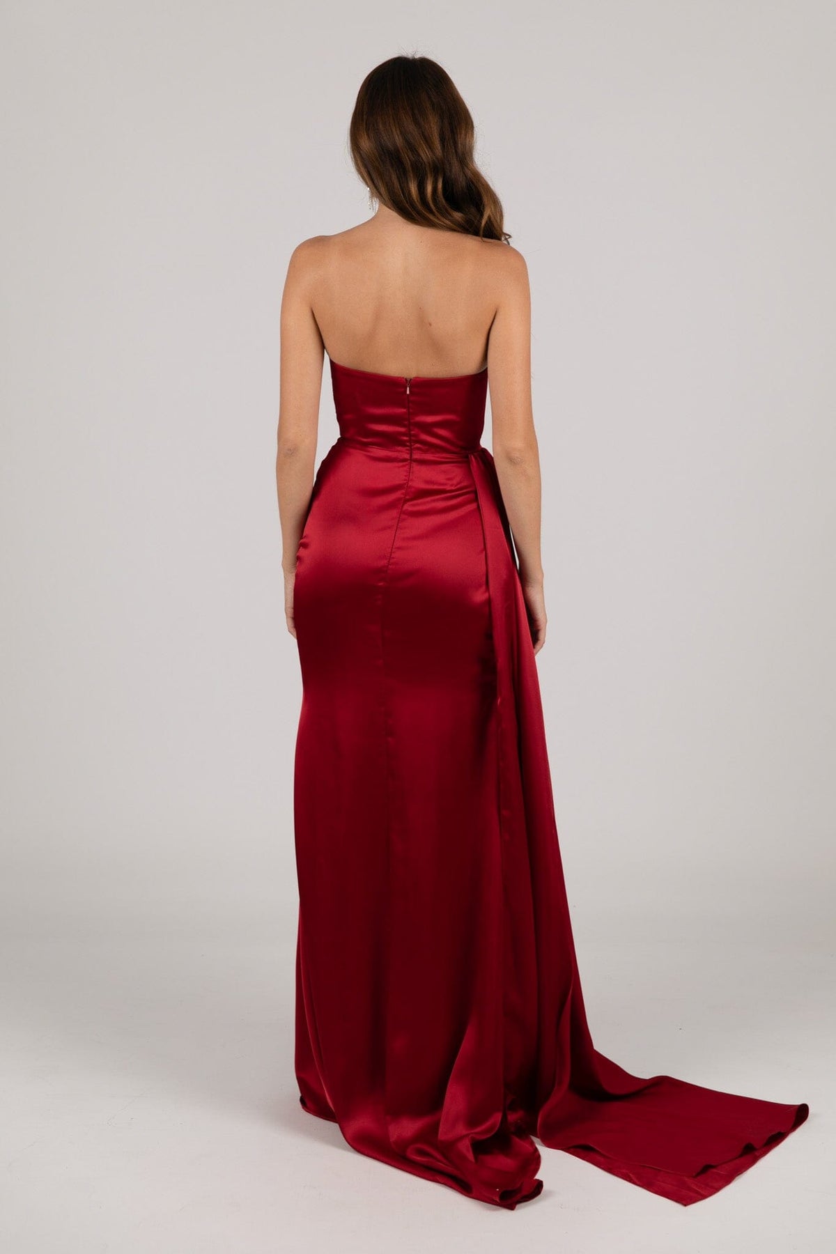 Half Open Back of Deep Red Satin Evening Gown with Strapless Bodice, Gathered Detail at Bust and Waist and High Side Slit