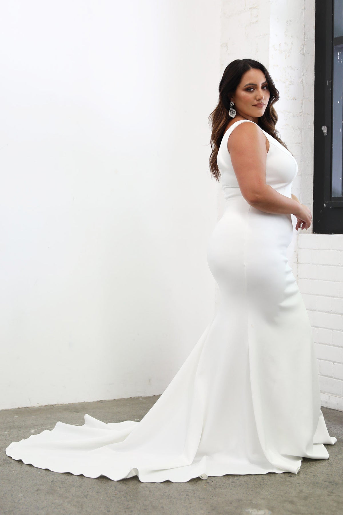 Side Image of Medium Length Sweep Train of Plus Size Fitted Crepe Wedding Dress in Mermaid Silhouette with V-Neckline, Open V-Shape Back in Ivory Colour