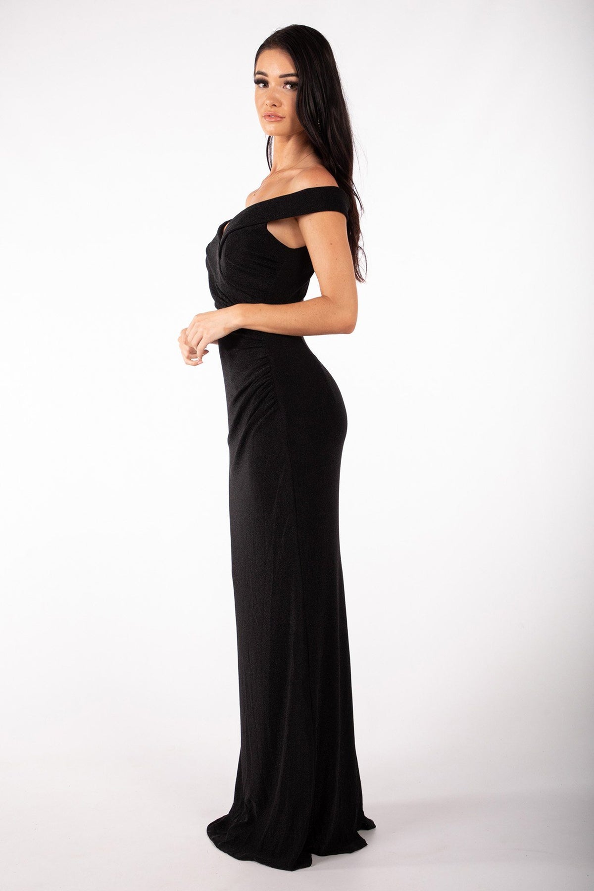 Side image of black glitter maxi dress with off-the-shoulder sweetheart neckline and gathering detail
