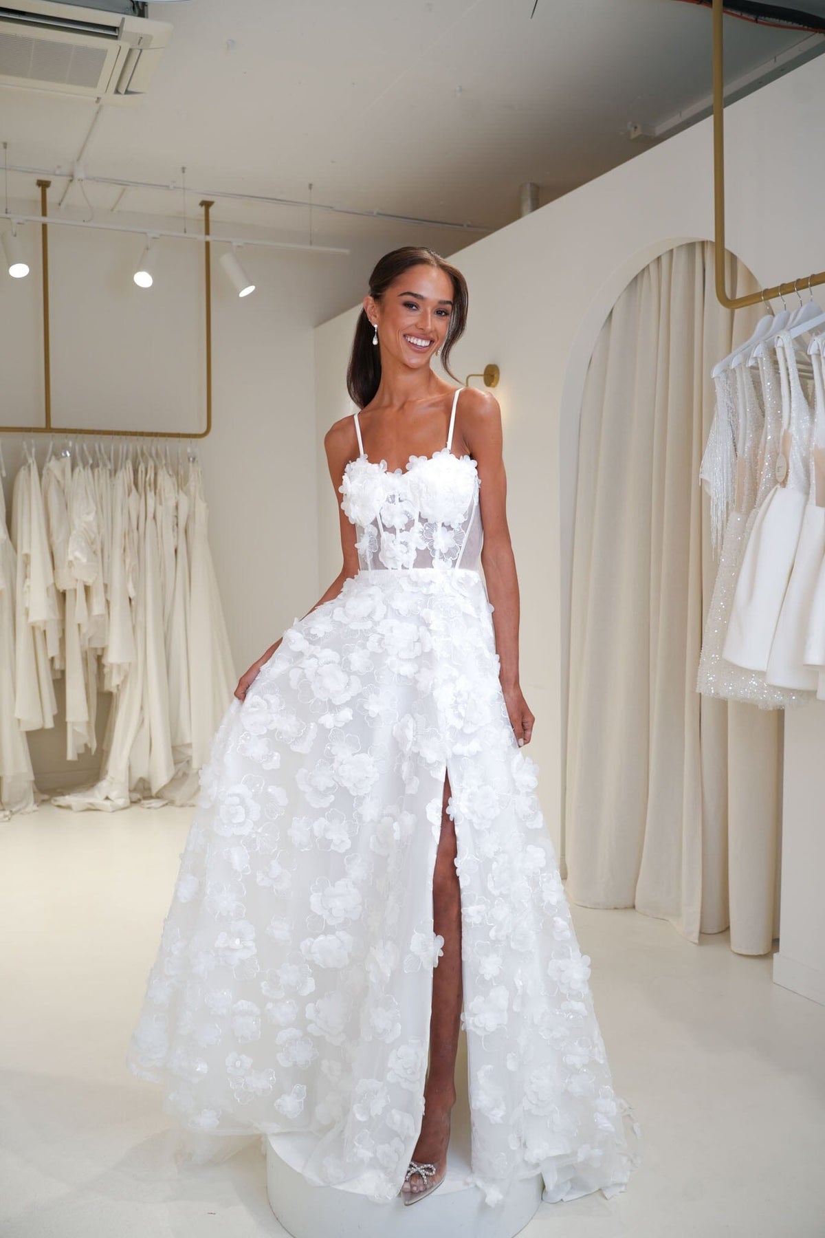 Young bride wearing the Francine 3D floral wedding dress in Noodz Boutique bridal shop