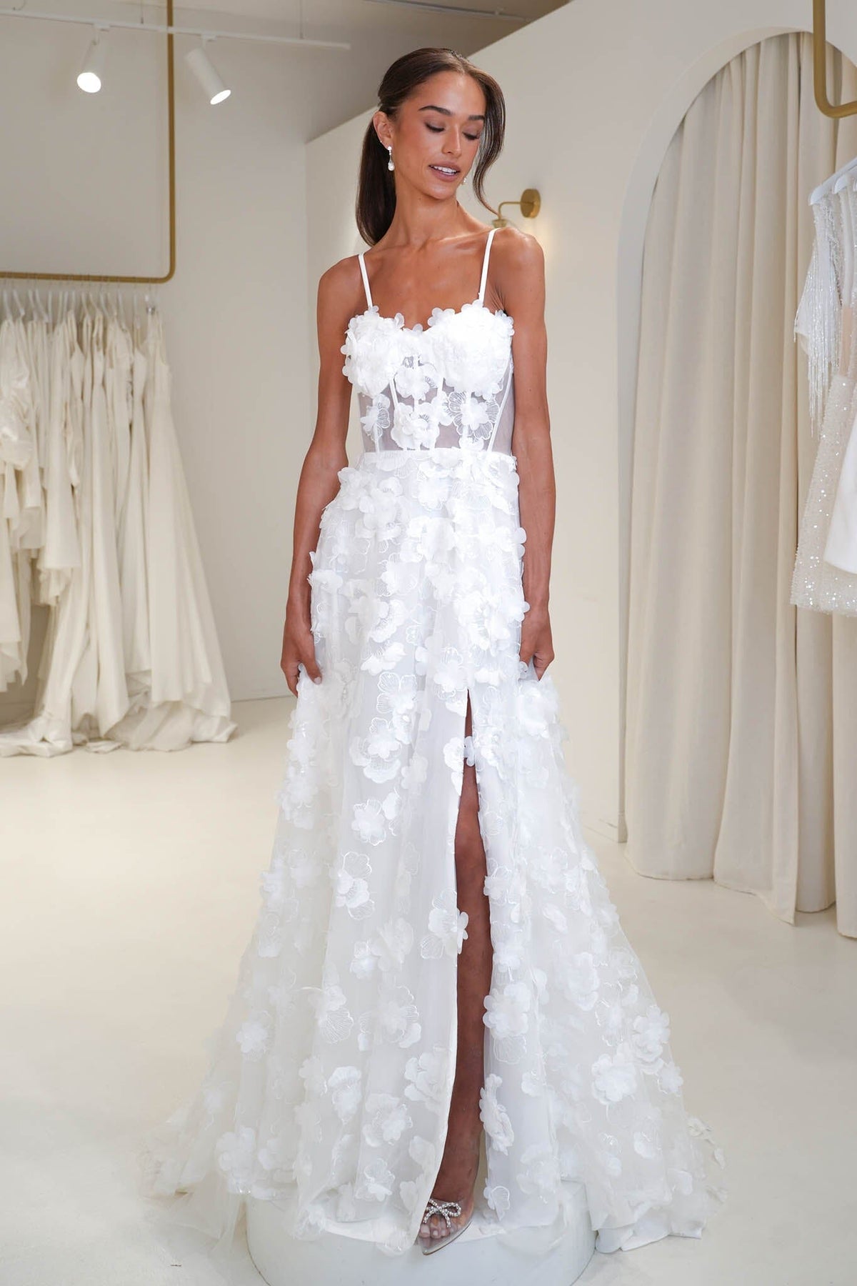 Young bride wearing the Francine 3D floral wedding dress in Noodz Boutique bridal shop