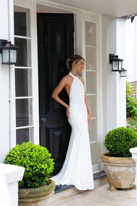 Low Cut Side Image of White High Neck Silky Satin Gown with Backless Design and Sweep Train