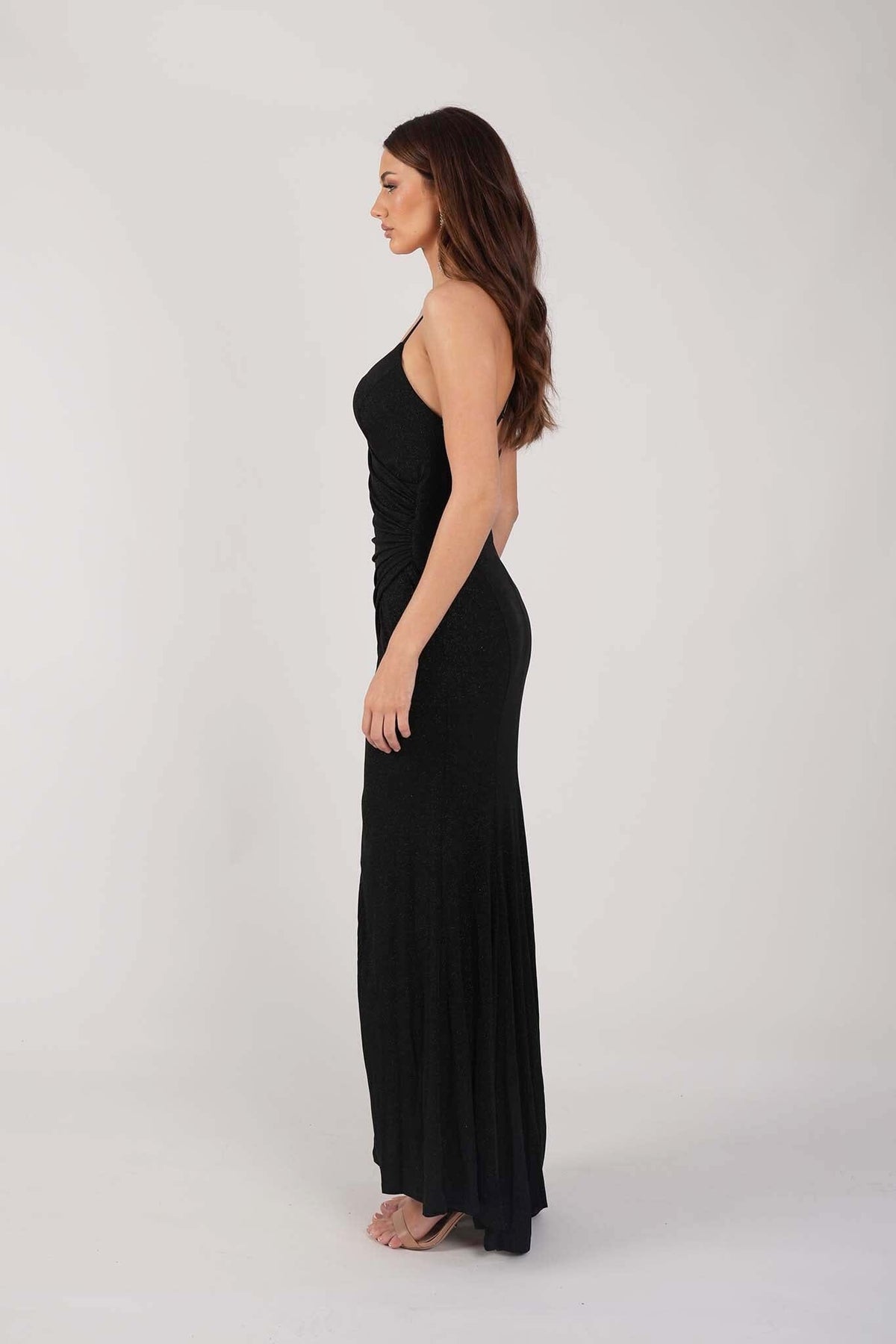 Side Image of Black Shimmer Fitted Maxi Dress with Thin Shoulder Straps, Gathered Detail at Waist and Leg Slit