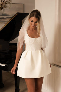 White Bridal Mini Dress with Beaded Corset-Style Bodice and Tulip Mini Skirt worn with a Tulle Bridal Veil