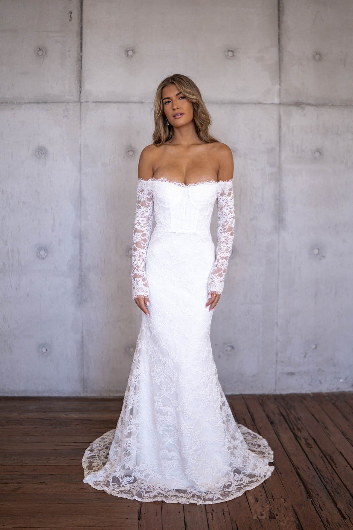 Ivory White Off The Shoulder Long Sleeve Lace Wedding Gown with Sweetheart Neckline, Corset Bodice and Fit and Flare Mermaid Silhouette