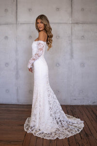 Sheer Sleeve of Ivory White Off The Shoulder Long Sleeve Lace Wedding Gown with Sweetheart Neckline, Corset Bodice and Fit and Flare Mermaid Silhouette