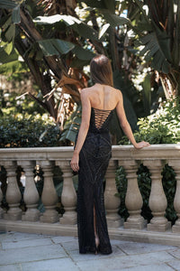 Full-length back view of RHEA black strapless formal gown with lace-up open back, fitted column silhouette and centre back skirt slit