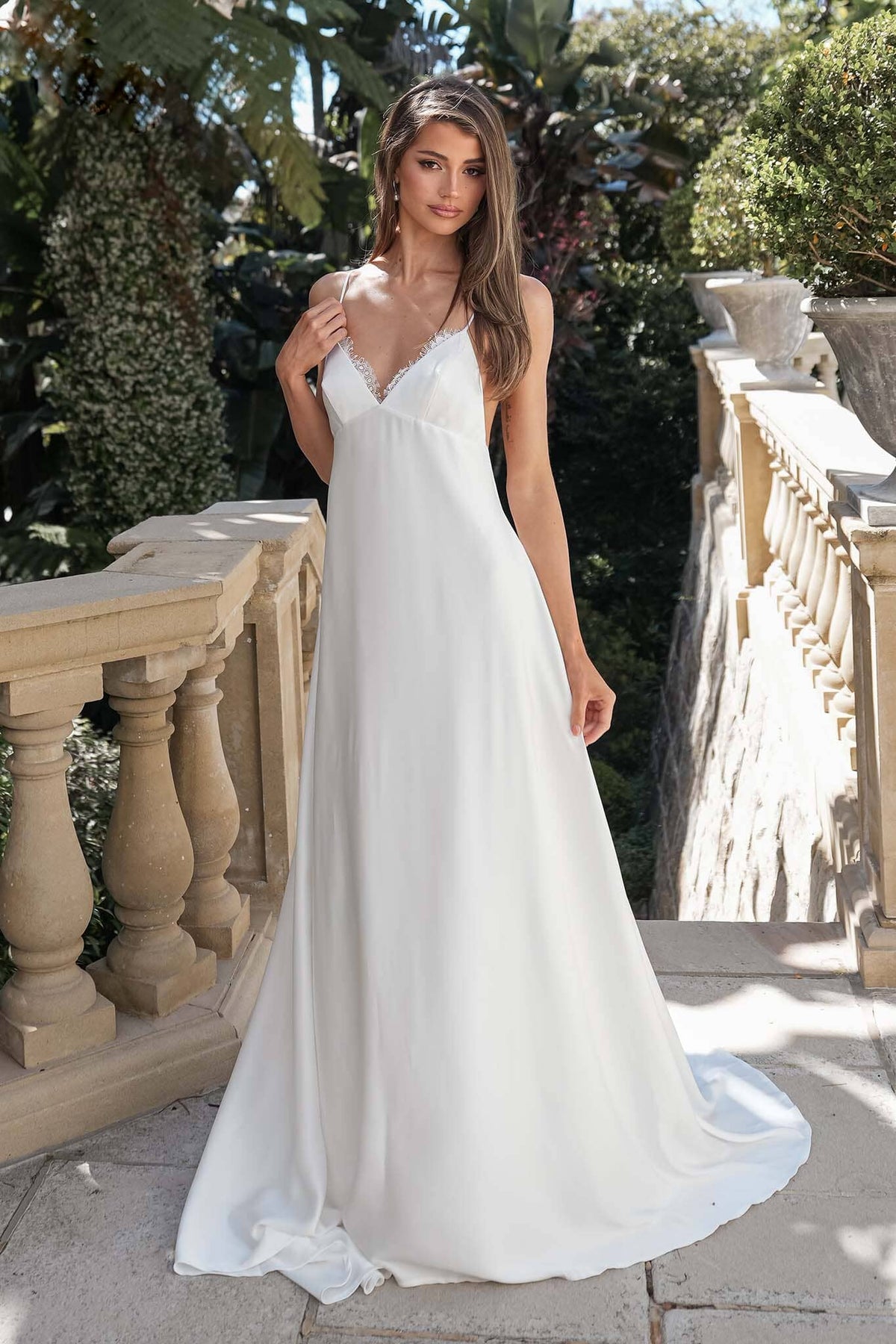ROSITA ivory elopement wedding dress featuring a lace-trimmed V-neckline, spaghetti straps and flowing A-line silhouette
