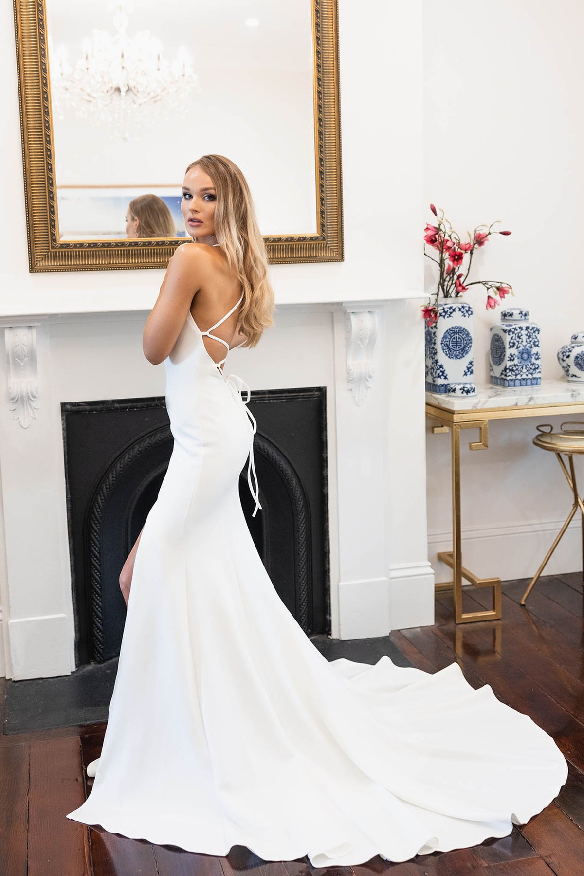 Side Image of Fitted Crepe Wedding Gown with V Neckline, Side Split and Lace Up Open Back in Ivory