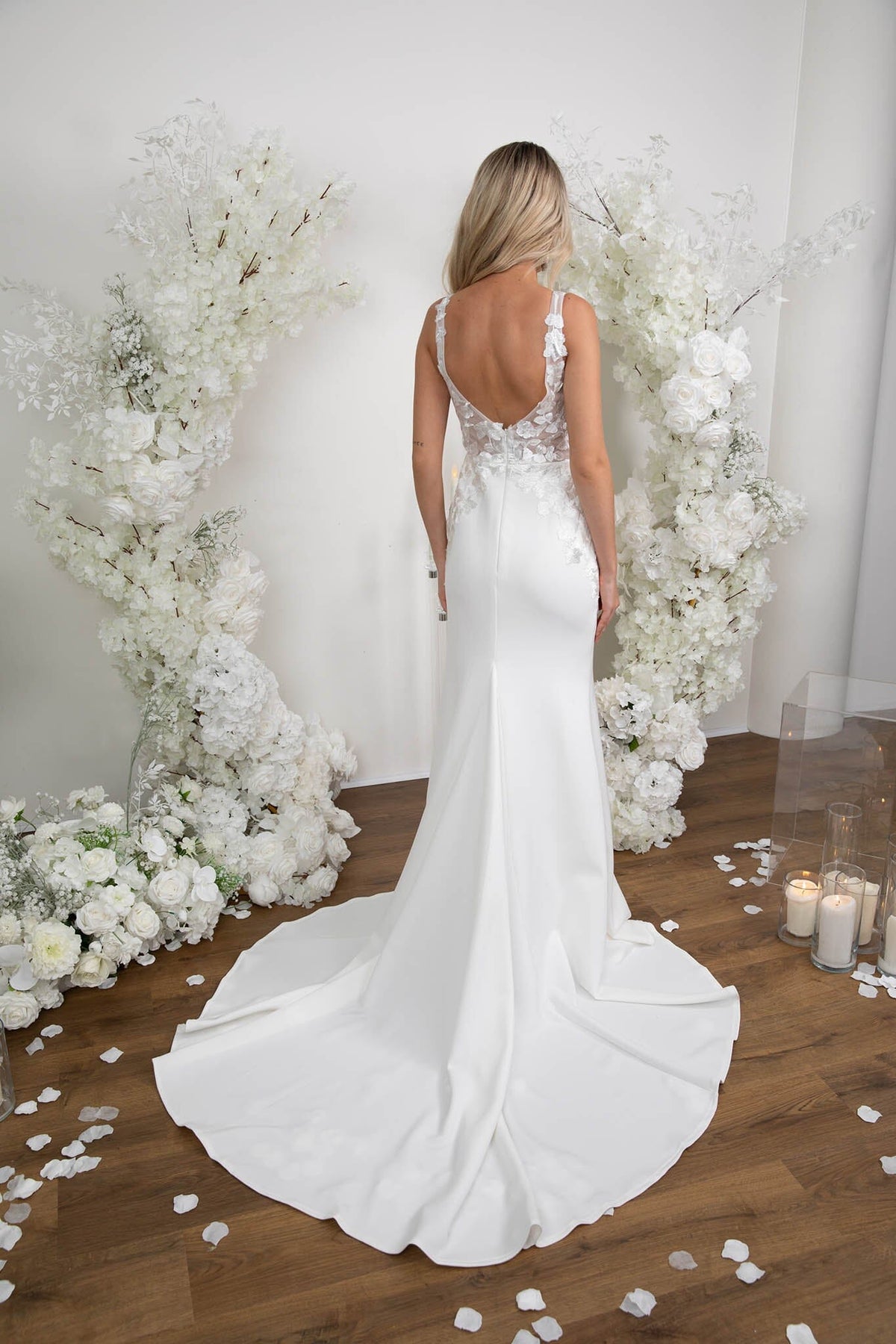 Back Image of Form Fitting Ivory White Wedding Gown with V Neck, Lace Motif Detailing, Open Back and Sweep Train