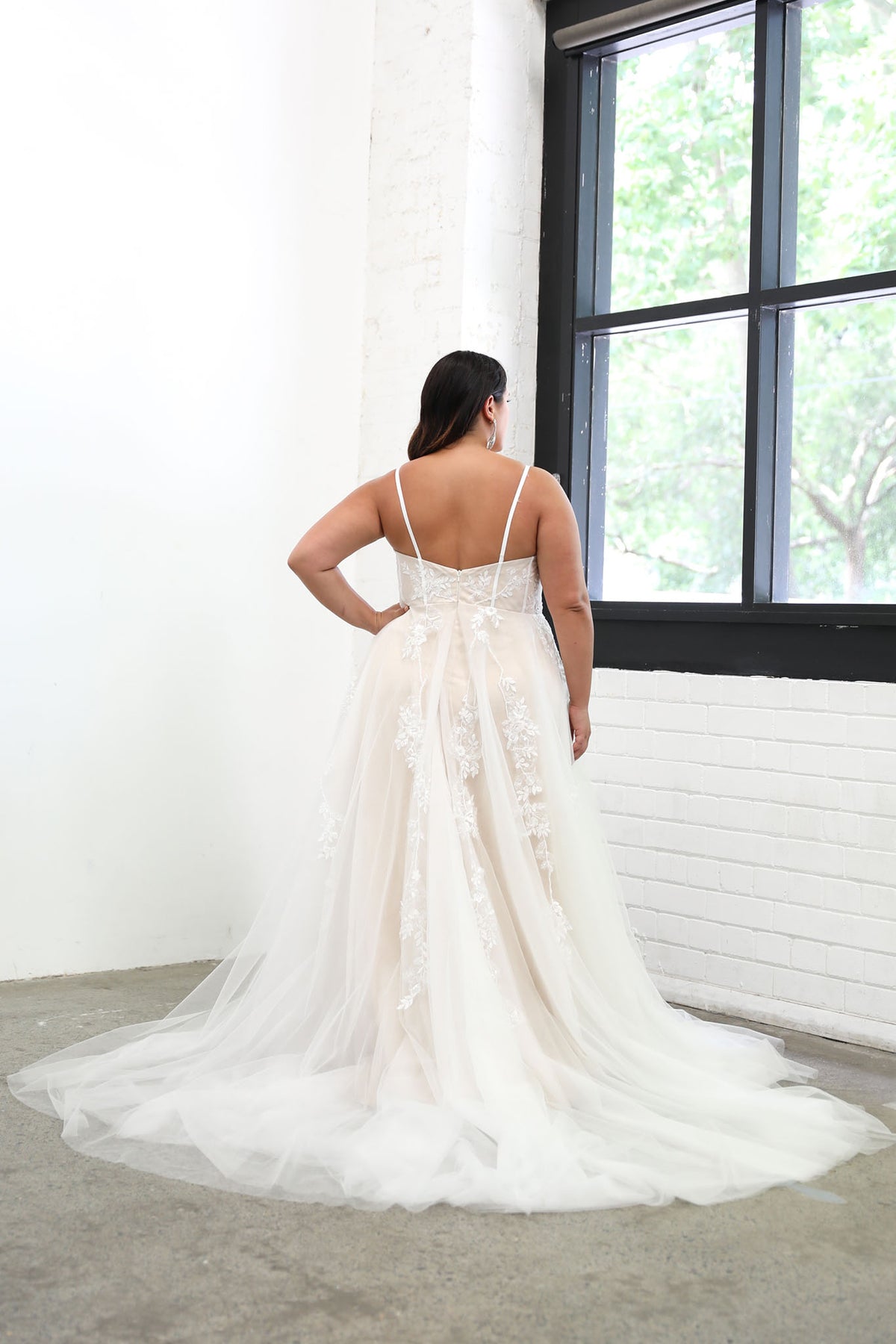 Back Image of Plus Size Bride wearing Ivory Off White Lace A-line Wedding Gown with Floral and Vine-like Lace Motifs Embellished on Layered Tulle, Trendy Exposed Bone Bodice, Voluminous Full A-line Skirt and Flowing Sweep Train