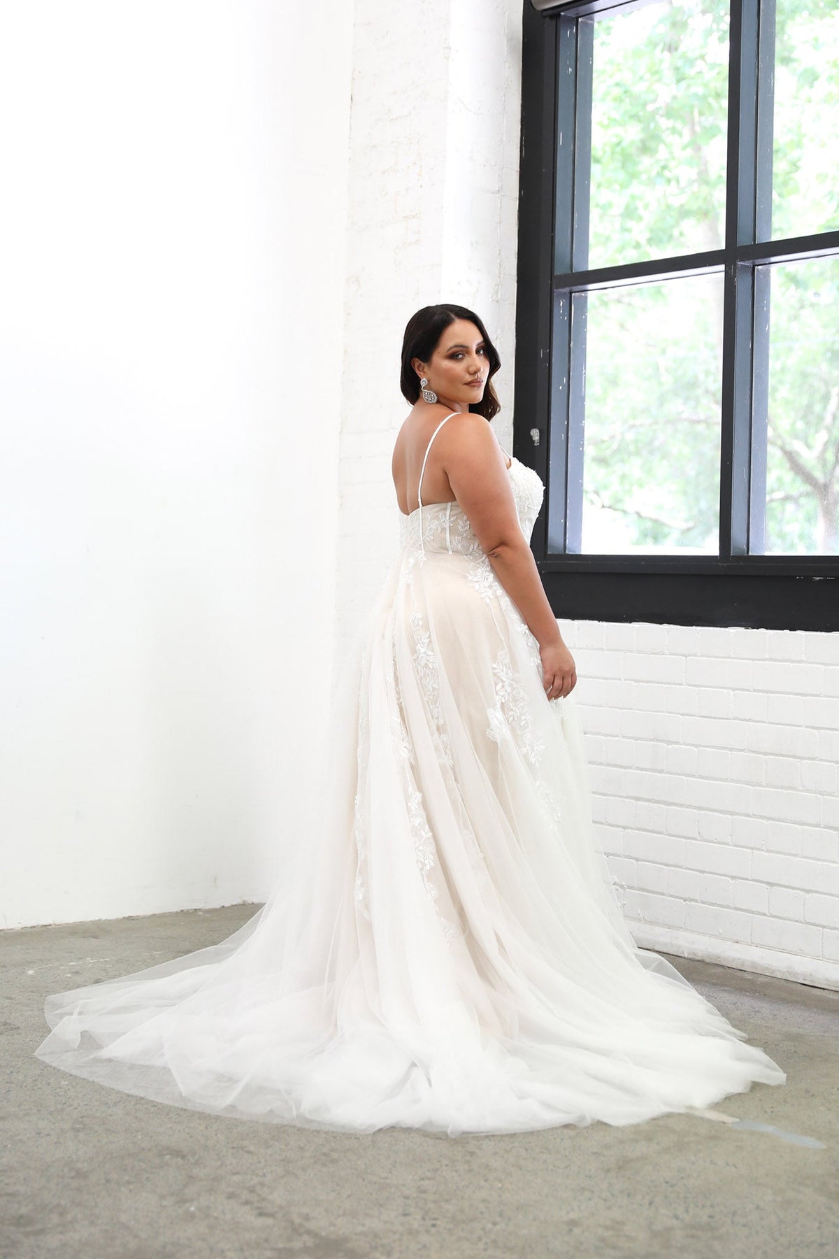 Plus Size Bride in Ivory Off White Lace A-line Wedding Gown with Floral and Vine-like Lace Motifs Embellished on Layered Tulle, Trendy Exposed Bone Bodice, Voluminous Full A-line Skirt and Flowing Sweep Train