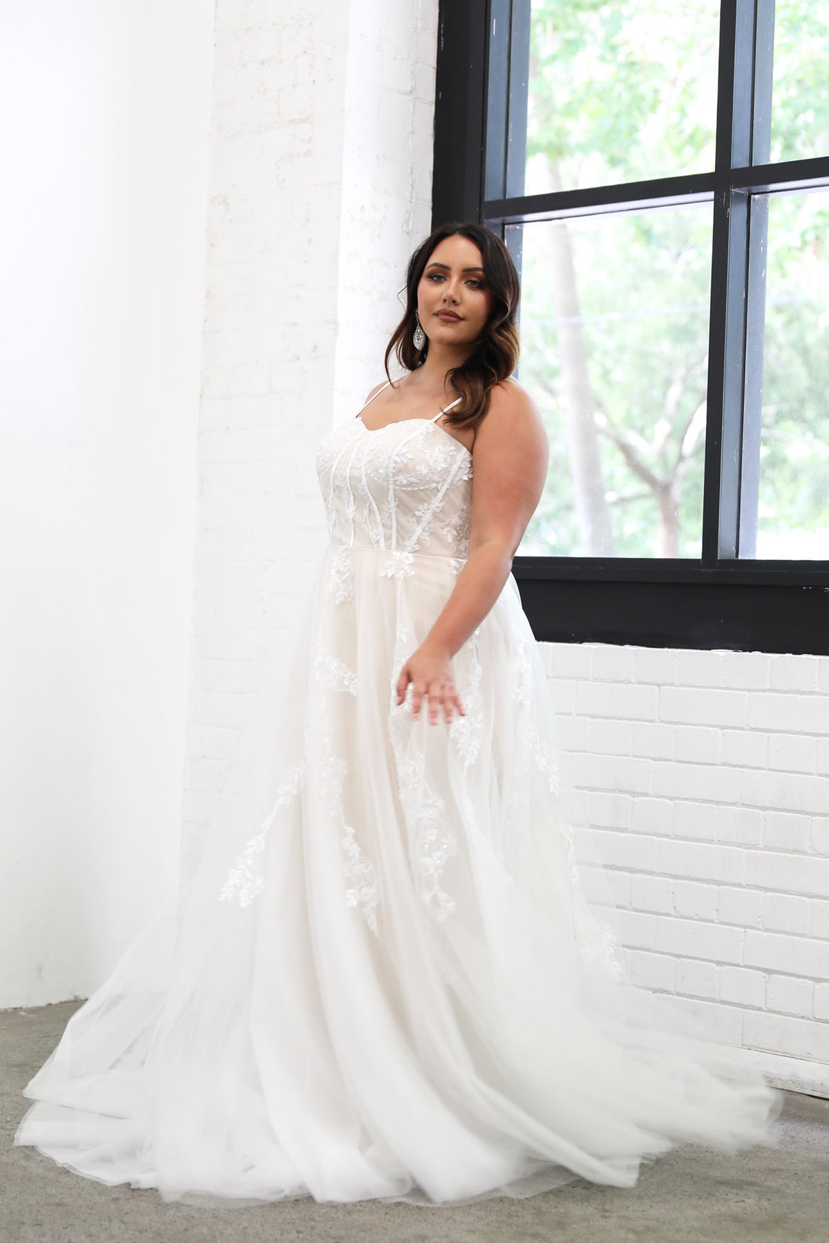 Plus Size Bride wearing Ivory Off White Lace A-line Wedding Gown with Floral and Vine-like Lace Motifs Embellished on Layered Tulle