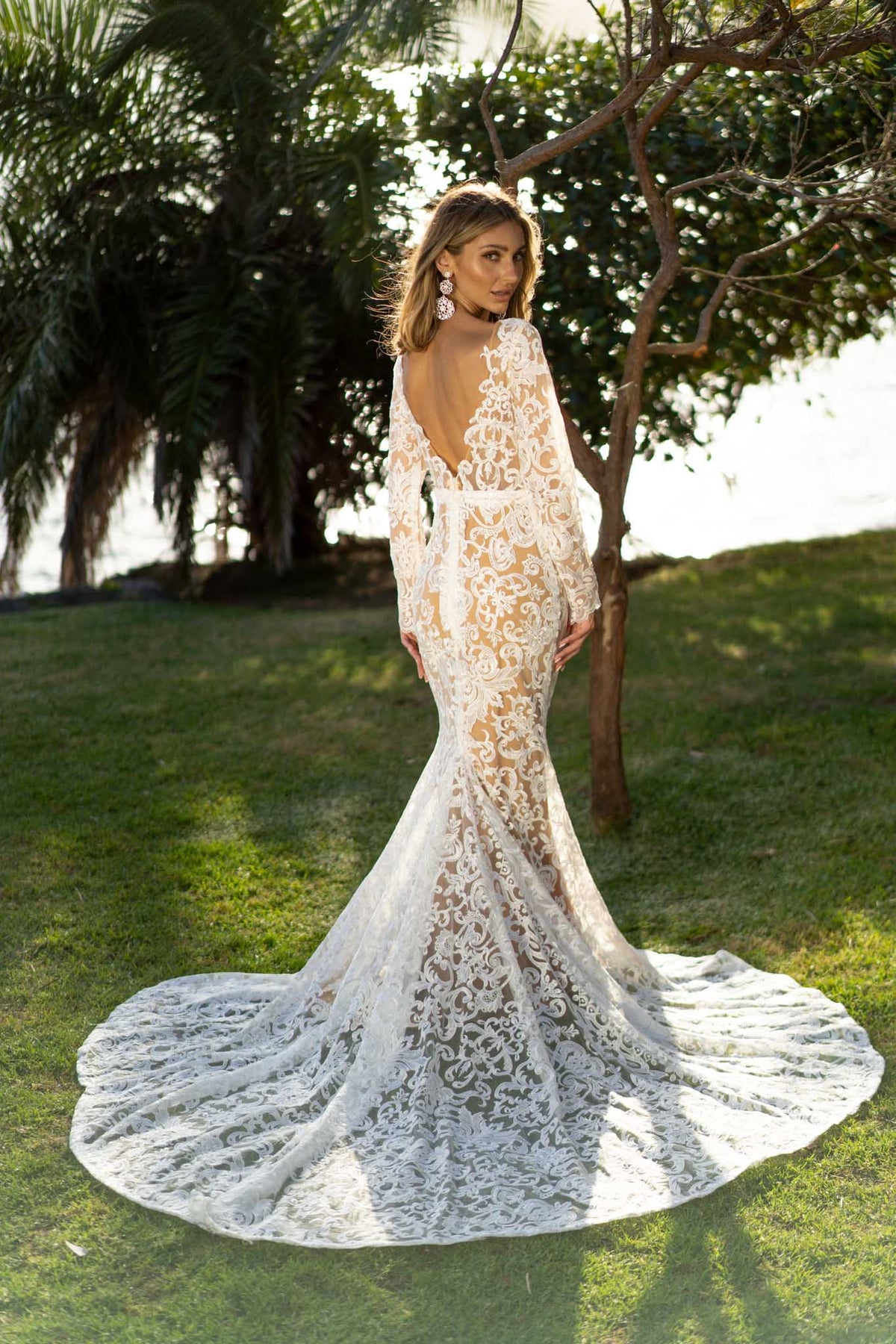 Long Sleeve Wedding Gown featuring White Vintage Inspired Lace Pattern with Chai Coloured Underlay in Sheer Illusion Design, Long Sleeves with Scalloped Edge, Fit and Flare Silhouette, Illusion V Plunging Neckline, Low Back and Sweep Train