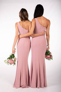 Back Image of Dusty Pink Bridesmaids One Shoulder Maxi-Length Dress with Asymmetrical Neckline, Waist Tie, Above Knee High Slit, and a Column Styled Silhouette