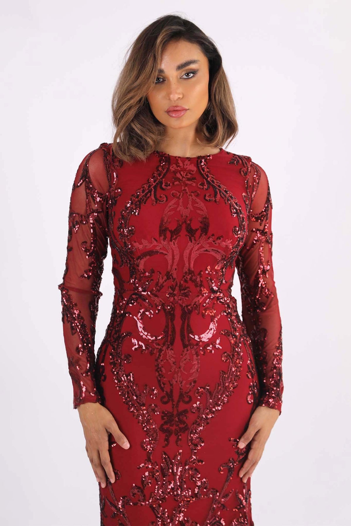 Close Up Image of Deep Red Long Sleeve Pattern Sequin Floor Length Evening Gown with Round Neck and Fit & Flare Silhouette