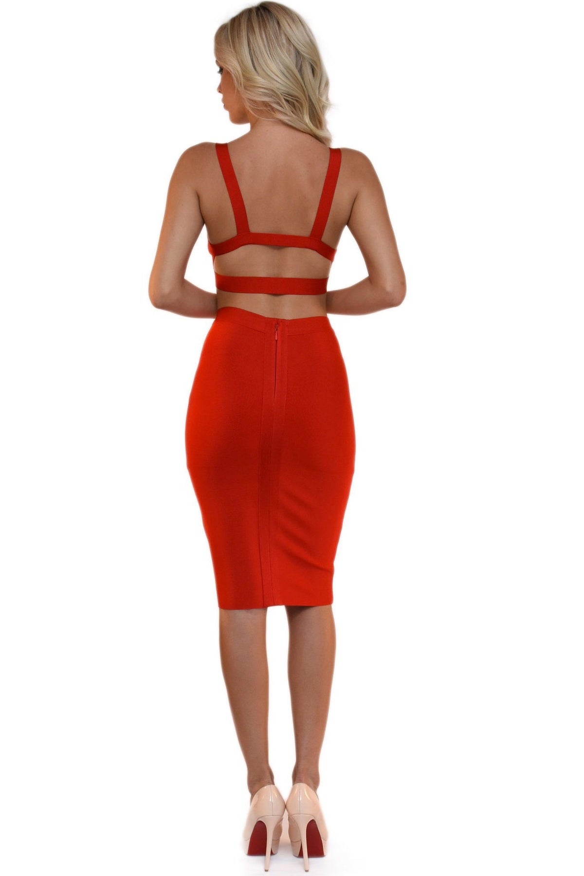 Back of red two-piece bandage dress including a bralette style top and a midi pencil skirt
