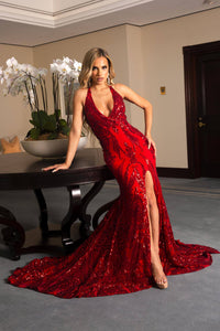 Red Full Length Evening Sequin Gown with Deep Red Embroidered Pattern Sequins Over Red Underlay, V neckline, Criss-cross Straps on Open Back, Thigh-high Side Slit, Fit and Flare Silhouette and Sweep Train