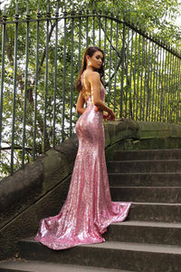 Long train design of bright pink sequin sleeveless evening long gown with deep V neckline, thigh-high slit, halter-neck strings, open back, and long train