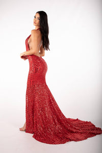 Side Image of red geometric sequin evening gown featuring halter V plunge neckline, high center front split, open back and sweep train
