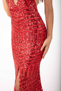 Close up image of material of red geometric sequin evening gown featuring halter V plunge neckline, high center front split, open back and sweep train