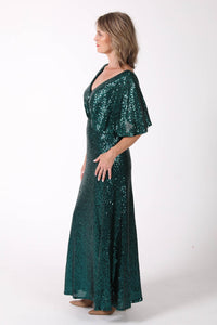 Side image of Mature woman sequin maxi dress with V neckline, butterfly sleeves, open back in emerald green