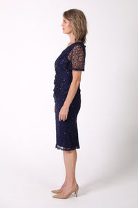 Side image of Mature woman sequin cocktail dress with V neckline and butterfly sleeves in navy color