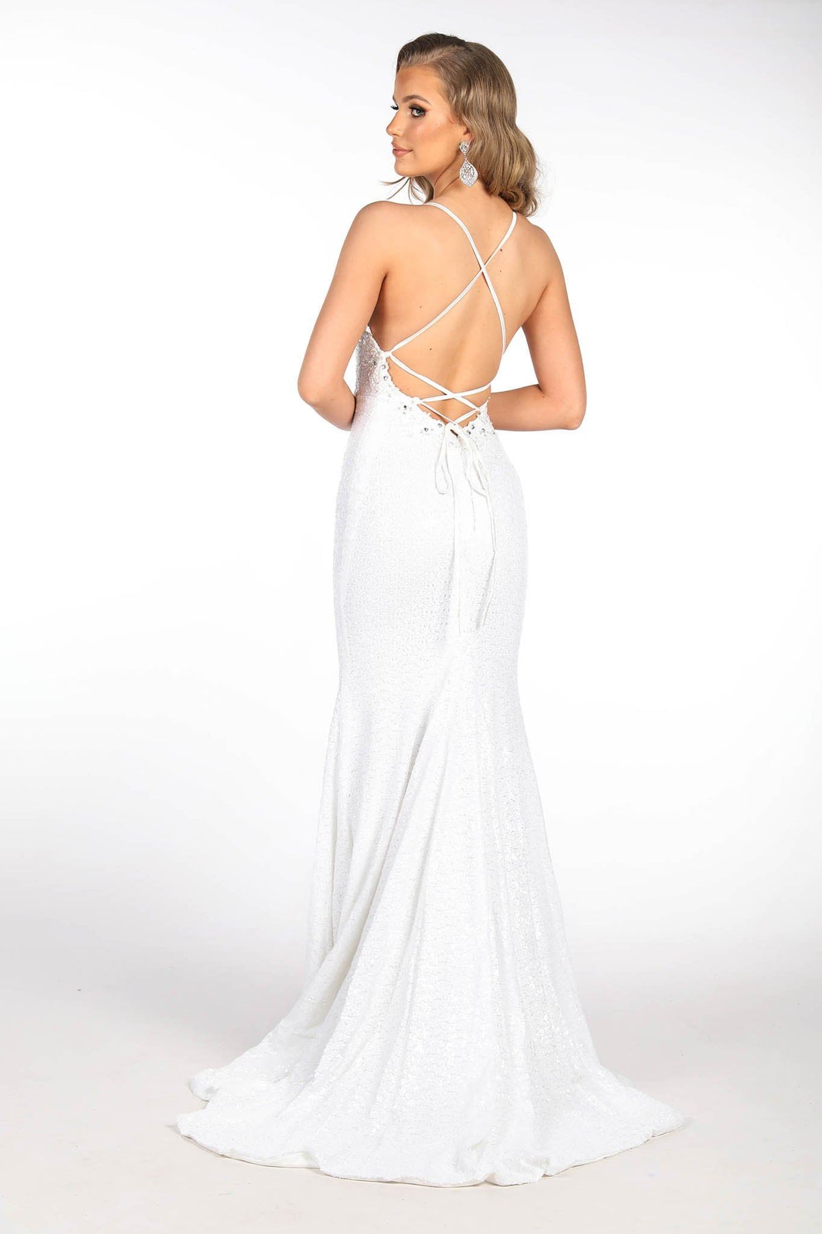 White full length sequin gown featuring hand beaded lace detail, V plunging neckline, thin straps with lace up on open back and sweep train