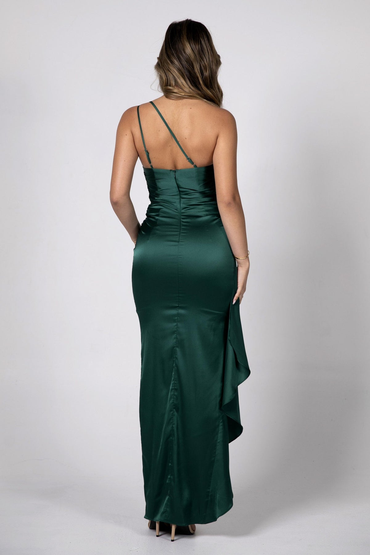 Back Image showing 2 adjustable back straps of Form Fitting Satin Maxi Dress with One Shoulder Neckline, Gathering Detail at Waist and Frill Hemline in Deep Green Color