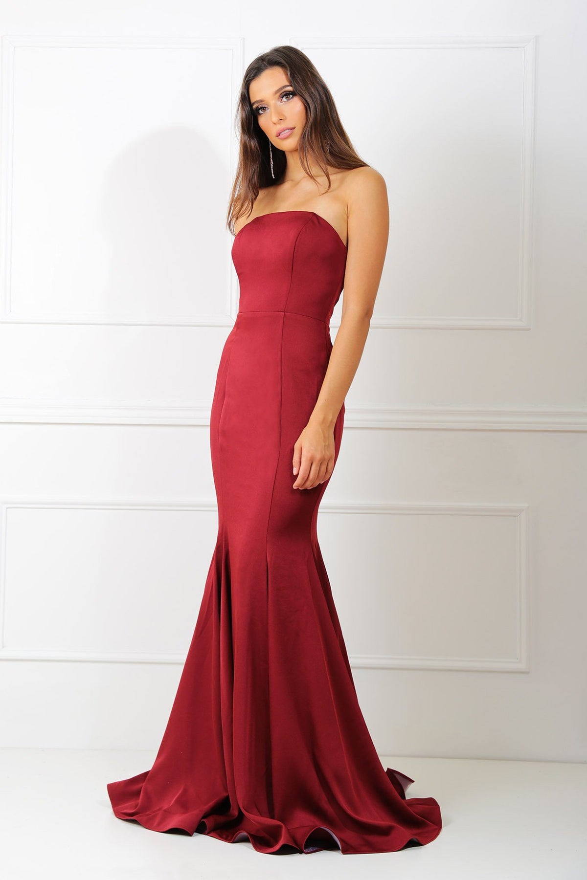 Wine red colored strapless straight neckline boned bodice fitted evening gown with floor sweeping train