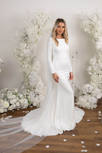 Ivory White Long Sleeve Fitted Wedding Gown with Boat Neckline, Closed Back and Long Train worn with Extra Long Veil